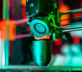 Close-up of a 3D printer laying down a layer