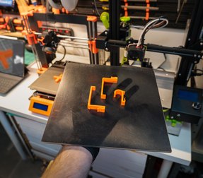 Fresh orange prints lifted off the build plate